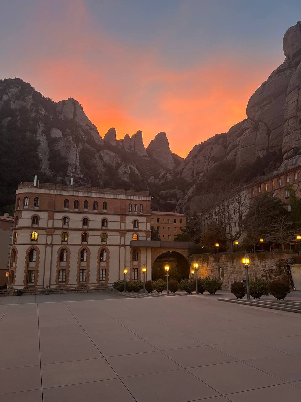 Montserrat at dusk, the monastery lit below the peaks